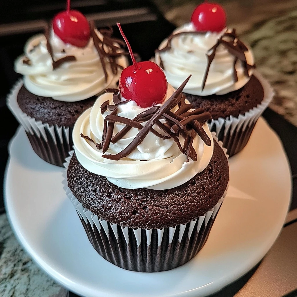 Delicious Black Forest Cupcakes topped with whipped cream and cherries