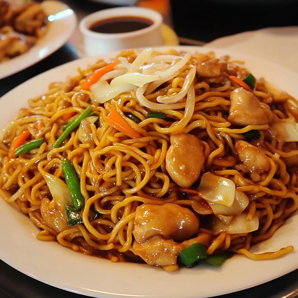 Delicious Chicken Chow Mein served with fresh vegetables and chicken pieces.