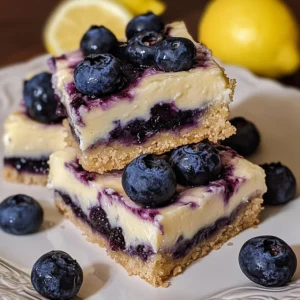 Blueberry lemon cheesecake bars topped with fresh blueberries and lemon zest