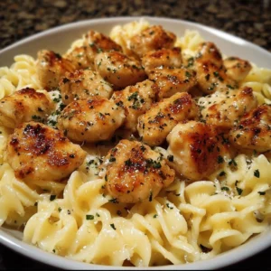 Garlic Butter Chicken Bites served with creamy Parmesan pasta on a plate