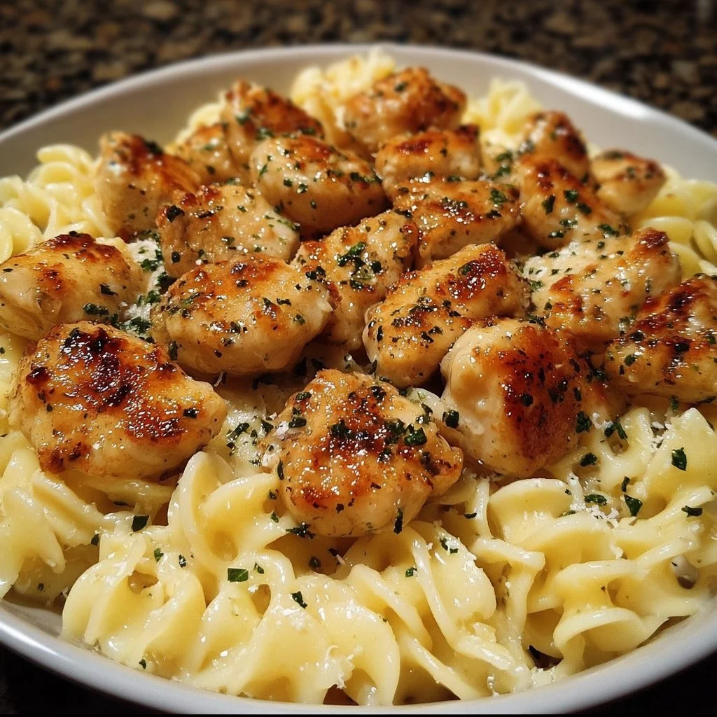 Garlic Butter Chicken Bites served with creamy Parmesan pasta on a plate