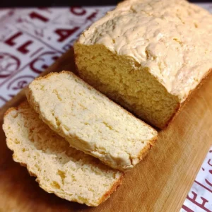 Loaf of gluten-free vegan bread on a wooden cutting board