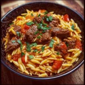 Delicious Greek beef orzo pasta served in a bowl with herbs and spices.