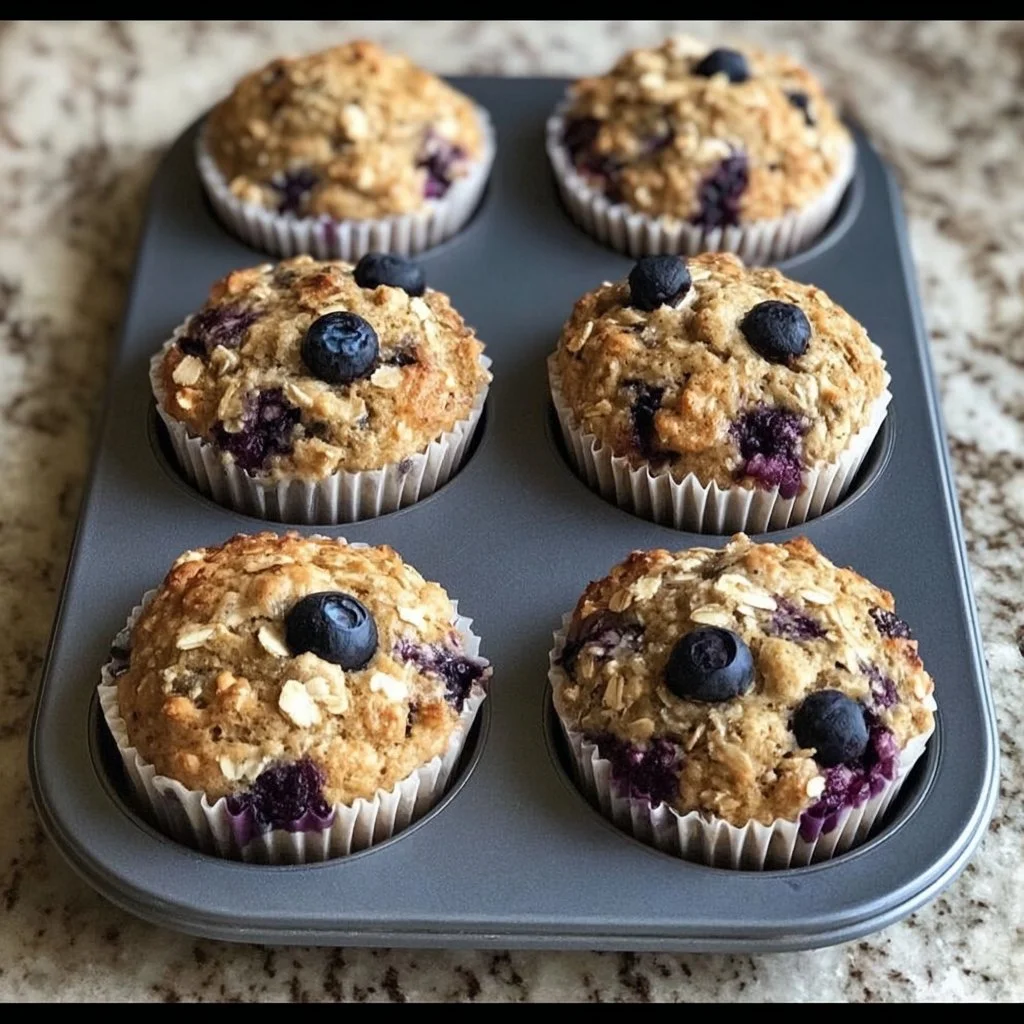 Healthy blueberry oatmeal muffins on a wooden table.