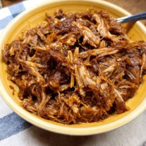 Tender Instant Pot Pulled Pork dish served with barbecue sauce