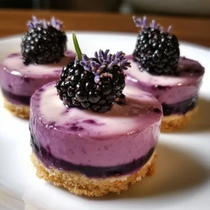 Mini Blackberry Lavender Cheesecakes served on a plate with fresh berries.