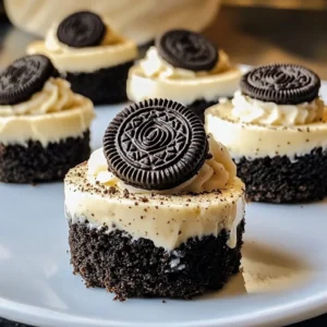 Mini Oreo cheesecakes topped with crushed Oreos and whipped cream