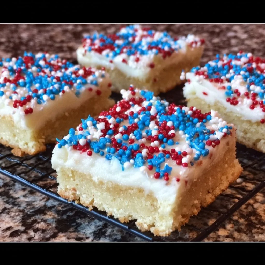 Patriotic sugar cookie bars decorated with red, white, and blue sprinkles