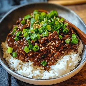 Plate of sticky ginger beef mince garnished with fresh herbs