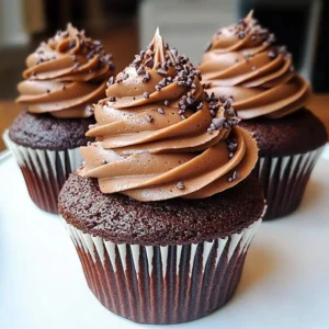 Delicious chocolate cupcakes topped with creamy icing and decorative sprinkles.