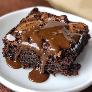Delicious fudge-y brownies topped with chocolate drizzle on a rustic wooden table