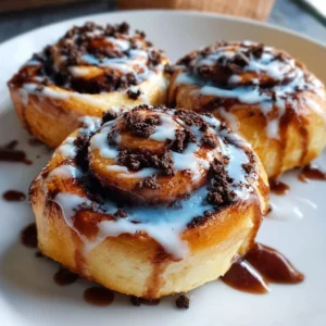 Cookie Monster cinnamon rolls with blue frosting and cookie dough on top