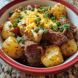 Crockpot Loaded Steak and Potato Bake topped with cheese and green onions.