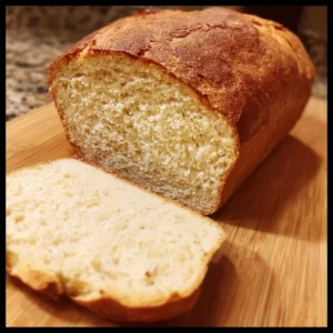 Slice of easy vegan gluten-free sandwich bread on a wooden cutting board