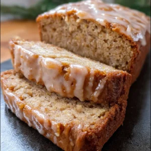Glazed eggnog banana bread with festive decorations and a delicious glaze.
