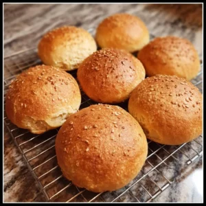Freshly baked gluten-free bread rolls on a wooden table