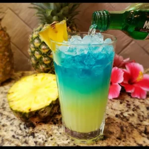 Malibu Rum and Blue Curacao Pineapple Drink served in a tropical glass