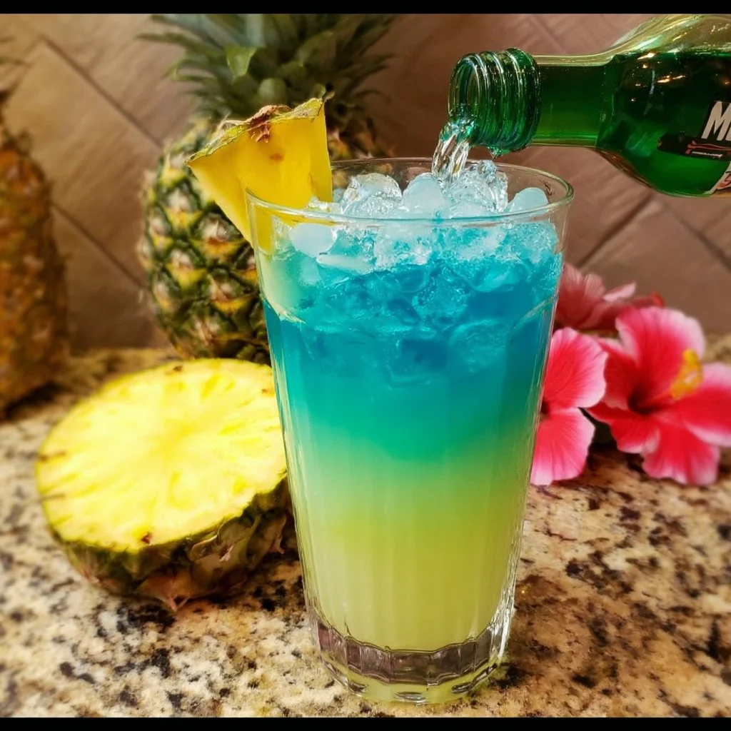 Malibu Rum and Blue Curacao Pineapple Drink served in a tropical glass