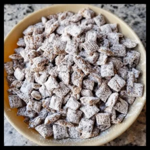 Delicious homemade Puppy Chow snack recipe in a bowl.