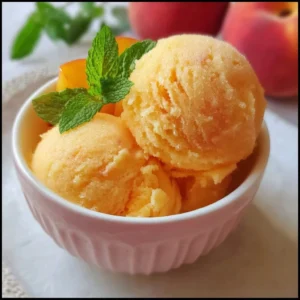 Homemade peach sorbet served in a bowl, perfect summer dessert