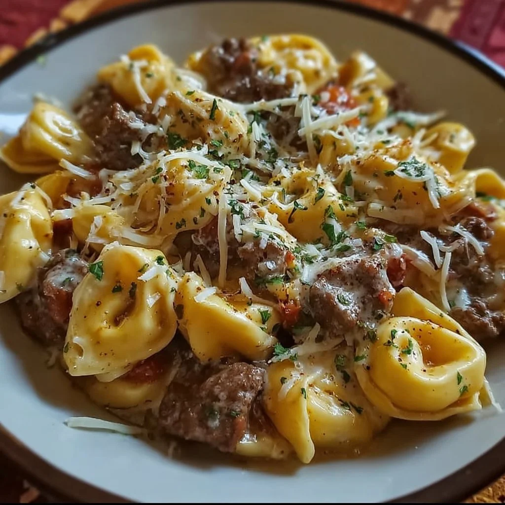 Plate of creative cheesesteak tortellini garnished with herbs