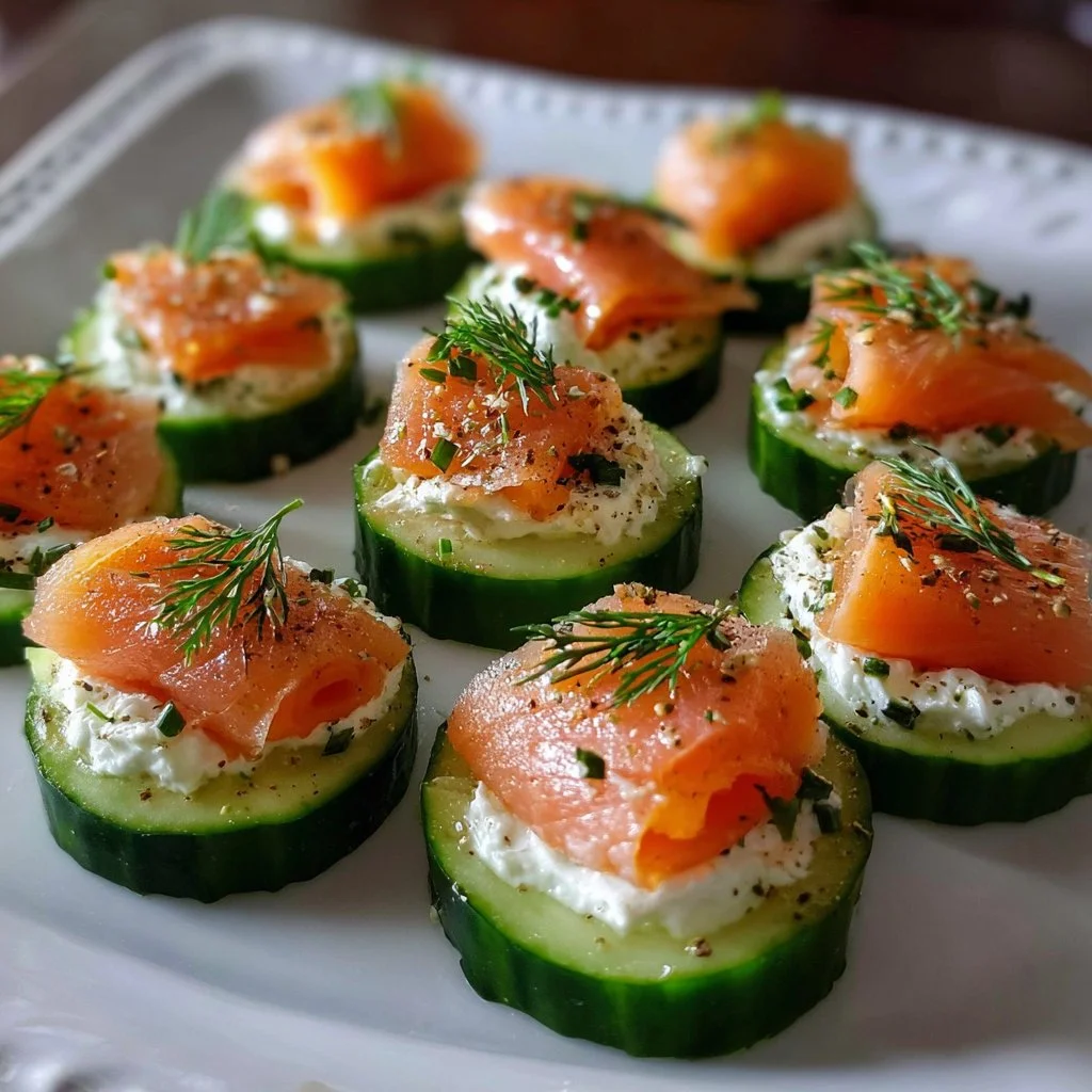 Cucumber smoked salmon bites garnished with dill on a serving platter