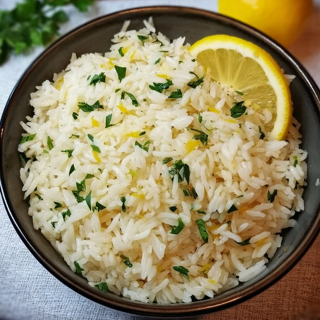 Bowl of Greek Lemon Rice garnished with fresh herbs and lemon slices