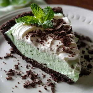 Delicious no bake mint chocolate pie topped with whipped cream and chocolate shavings.