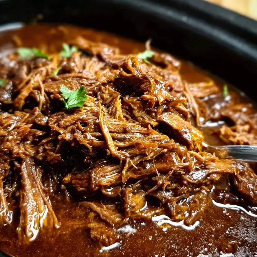 Delicious slow cooker barbacoa served in tacos with fresh toppings.