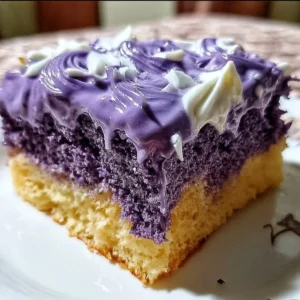 Slice of Ube Three Milks Cake topped with ube purple yam and cream