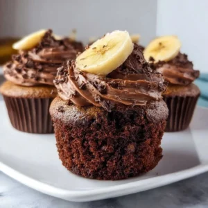 Delicious Chocolate Banana Cupcakes with creamy frosting on a white plate