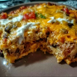 Creamy burrito casserole served in a baking dish with garnishes.
