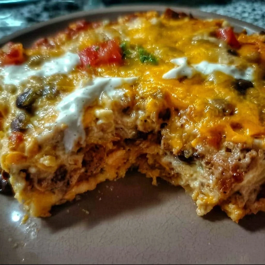 Creamy burrito casserole served in a baking dish with garnishes.