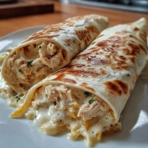 Creamy Cheesy Chicken Alfredo Wraps with fresh ingredients on a plate
