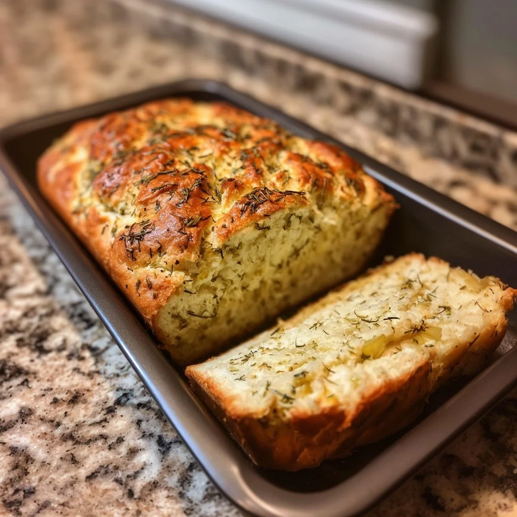 Freshly baked Dill Pickle Bread loaf with pickles and herbs