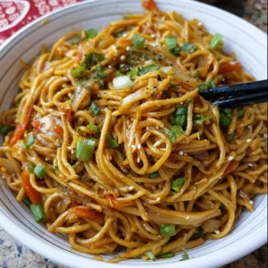 A bowl of hassle-free one-pot teriyaki noodles with fresh vegetables and sauce.