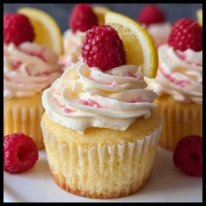 Delicious lemon raspberry cupcakes with vibrant frosting and fresh raspberries on top.