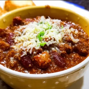 A bowl of my husband's best stovetop chili topped with cilantro and cheese.