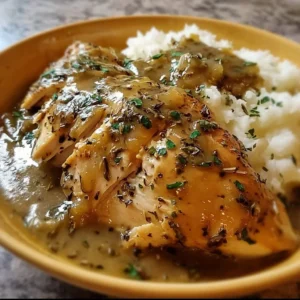Slow cooker chicken and gravy served with mashed potatoes