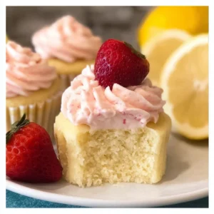 Strawberry lemonade cupcakes with vibrant frosting and strawberry garnish