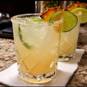 A selection of vibrant mezcal cocktails garnished with fresh ingredients.