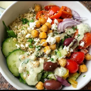 Colorful Mediterranean Quinoa Bowl with fresh vegetables and herbs.