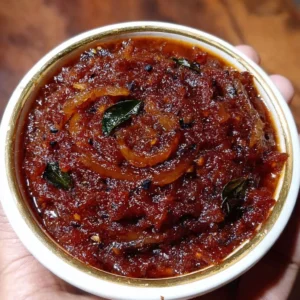 Homemade onion chutney served in a bowl with fresh spices