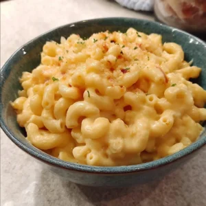 Creamy stovetop mac and cheese served in a bowl with cheese on top