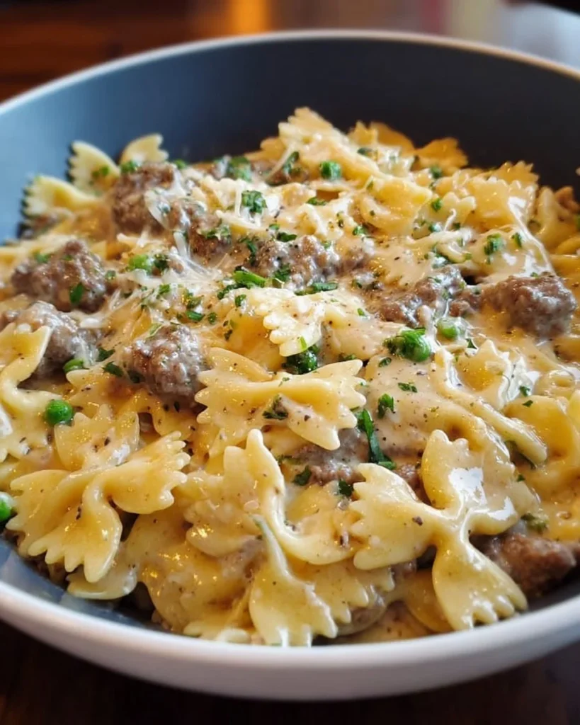Creamy Beef & Bowtie Pasta served on a plate with fresh herbs.