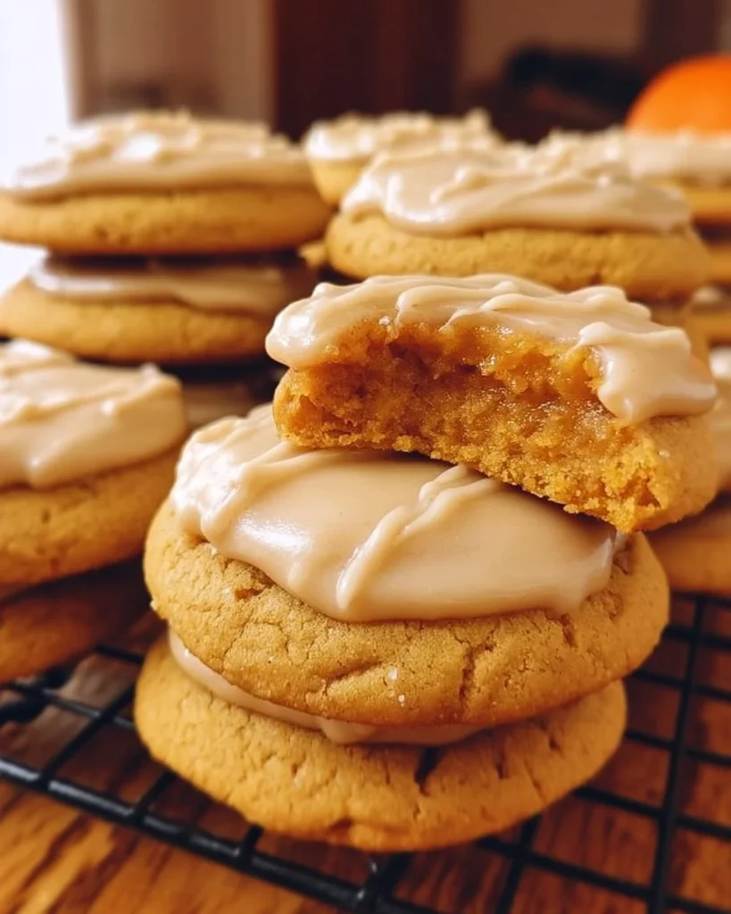 Delicious pumpkin cookies with brown butter frosting on a wooden table