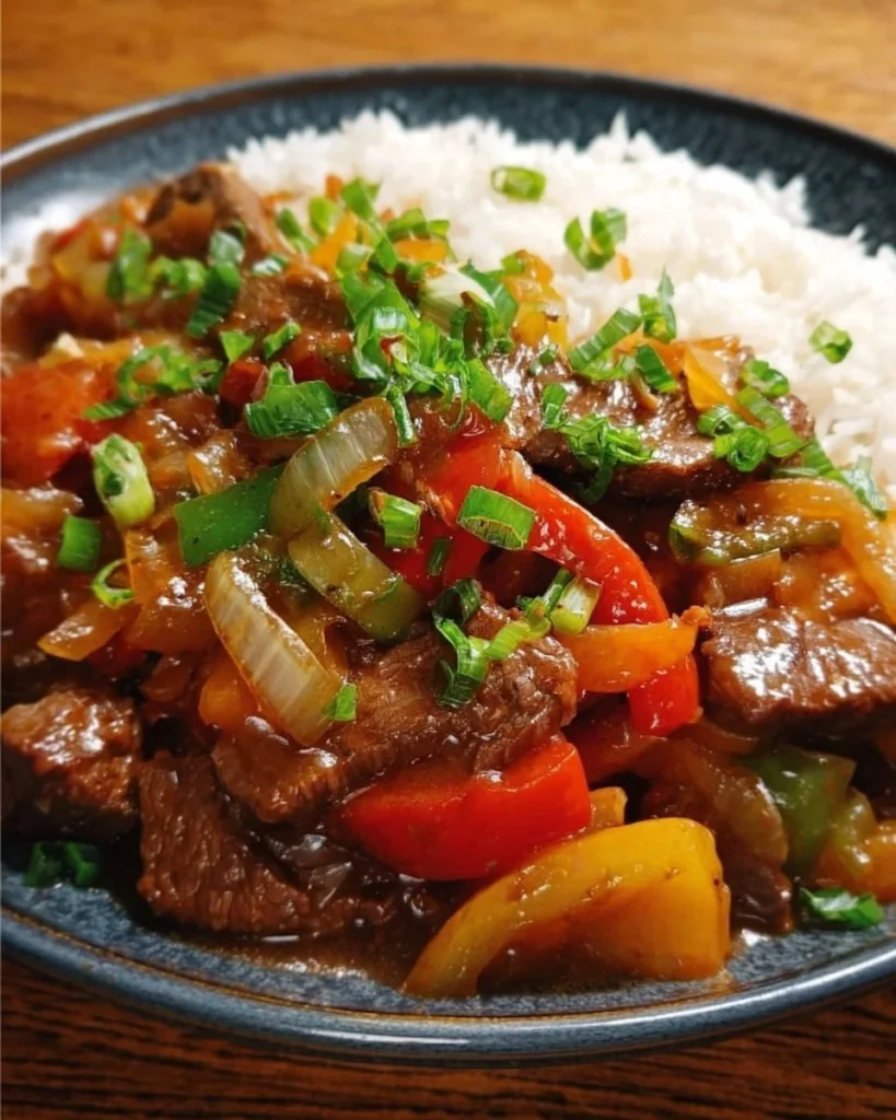 Succulent slow cooker pepper steak served with bell peppers and sauce.