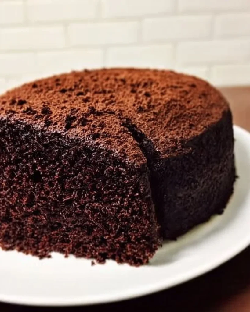 Delicious slice of amazing chocolate cake topped with chocolate icing and sprinkles