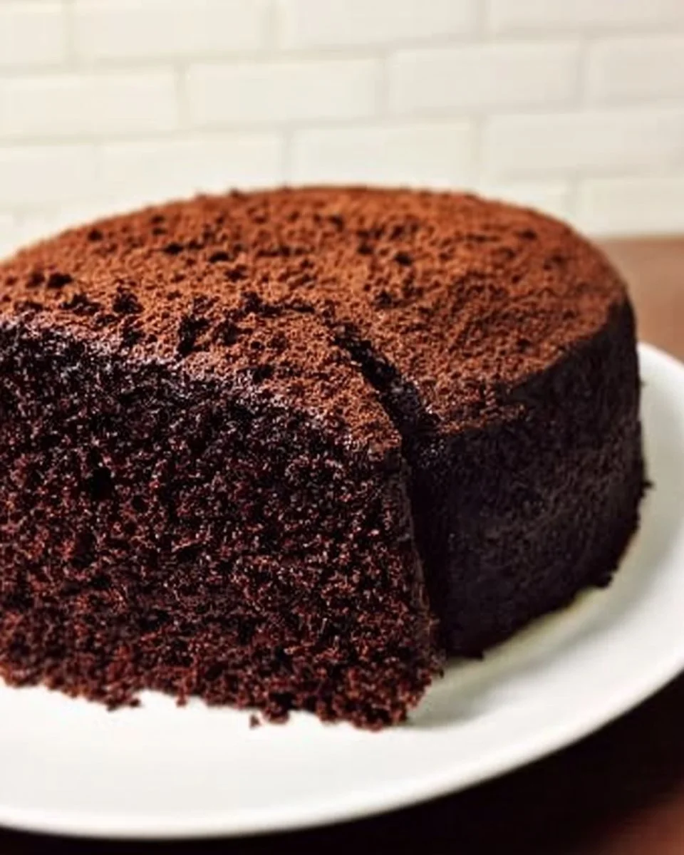 Delicious slice of amazing chocolate cake topped with chocolate icing and sprinkles