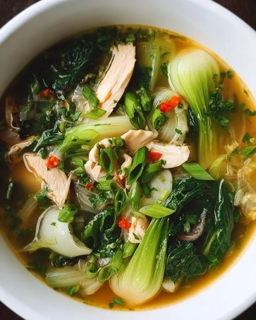 A bowl of hearty Bokchoy Chicken Soup with vegetables and tender chicken.